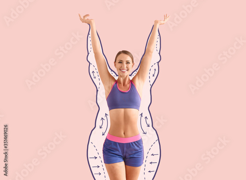 Happy sporty woman after weight loss on color background