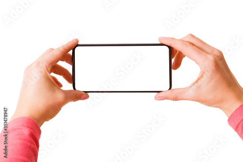 Person holding in hands smartphone with blank screen and taking picture or recording video, photo isolated on white background