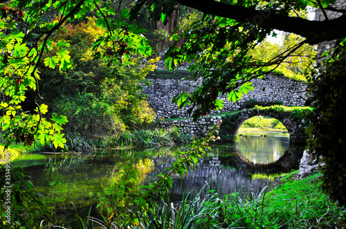 Garden of ninfa: detail of ancient stone bridge.