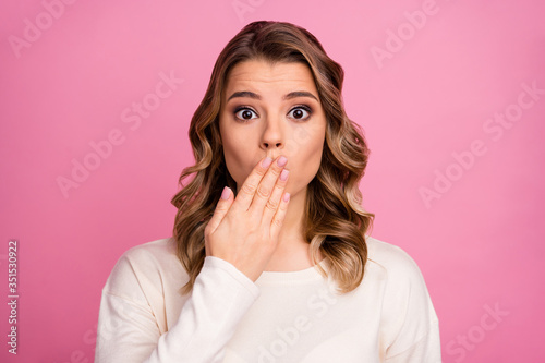 Close-up portrait of her she nice-looking attractive lovely pretty charming confused wavy-haired girl closing mouth awkward news isolated over pink pastel color background