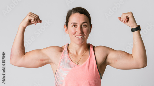 Female athlete flexing her arms