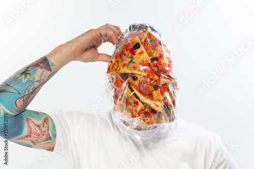 Male face covered with oilcloth, cellophane and unhealthy food, hard to breathe. People lost their faces, can't notice the environmental pollution made by themself. Garbage, problem, breathing.