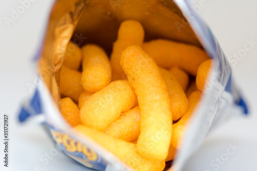 Cheese puffs snack in silver foiled package