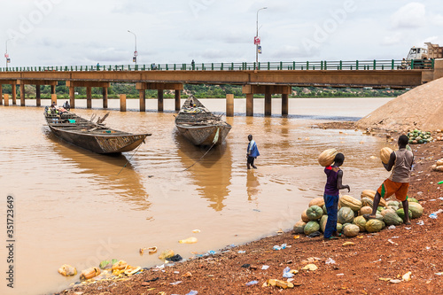 Wooden boats on Niger River muddy water 