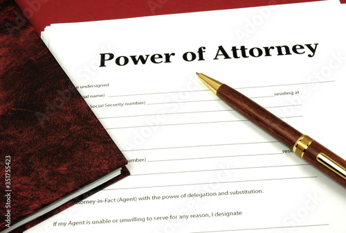 Power of Attorney Form ready to sign with book and pen.