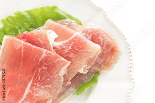 sliced ham on plate with copy space for gourmet