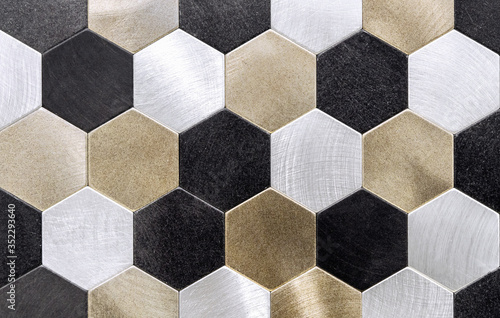 Metal mosaic tile with golden, silvery and black honeycombs.