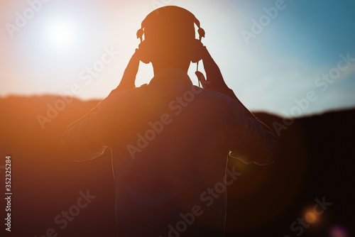 stylish bearded man in headphones listening to music