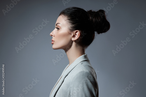 Portrait of a fashion woman with a bunch of hair. Perfect face profile girl, natural cosmetics for face care