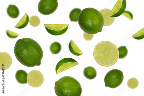 Falling limes isolated on a white background with clipping path as package design element. Flying fruits.