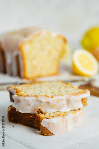 Close up of slices of glazed lemon pound cake loaf with poppy seedseed