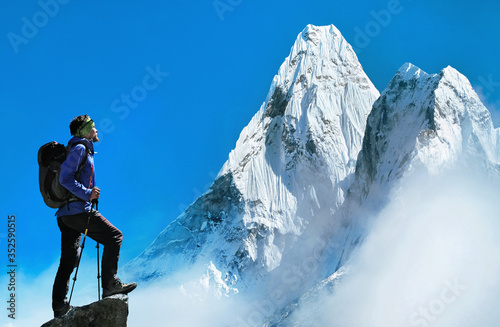 Hiking in mountains. Traveler with backpack on a top of a mountain