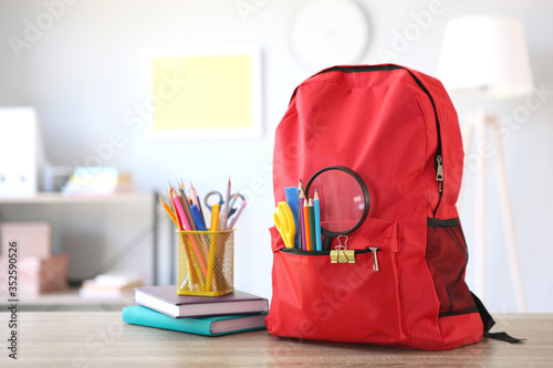 school backpack and stationery in a bright room. Preparing for school. Back to school. Place for text. National School Backpack Awareness Day