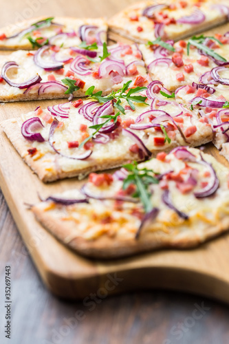 Flammkuchen - Traditional French dish tarte flambee cream cheese, bacon and onions