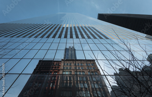 New York City, USA - 26 Dec 2019: Reflection of old Buildings in the Glass Facade of the 4 World Trade Center Skyscraper