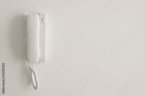 White telephone on a white wall. Copyspace.