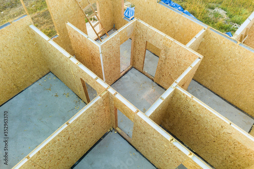 Construction of new and modern modular house. Walls made from composite wooden sip panels with styrofoam insulation inside. Building new frame of energy efficient home concept.