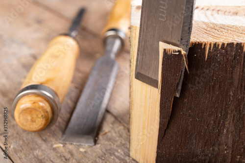 Work with a carpenter's chisel in pine wood. Small carpentry work in the home workshop.