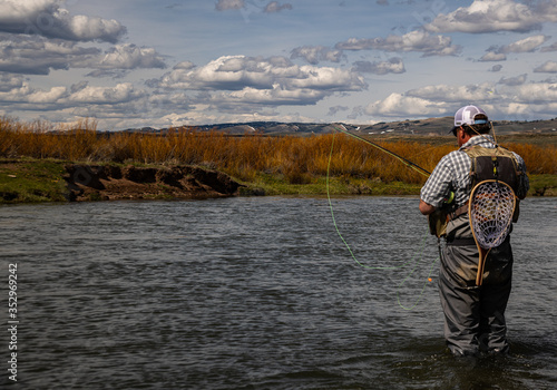 A man fly fishing on a western trout stream in the spring.