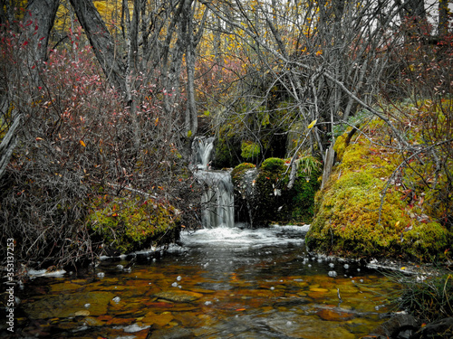 A small waterfall in the autumn forest