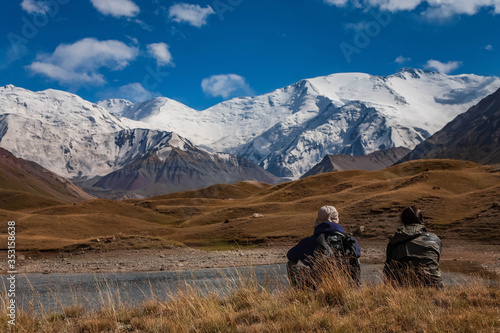 Beautiful mountainious landscape. Snowy mountain peaks. Hilly valley.