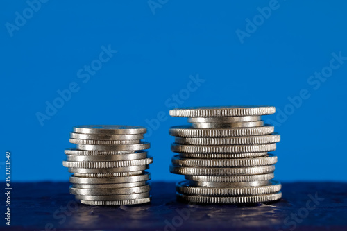 Two piles of Swiss coins shown on blue background