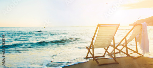 Background with couple of deck chairs at sunset, Travel concept, Summer background