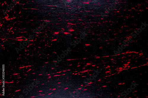 Red and black melted painted wooden board texture background.