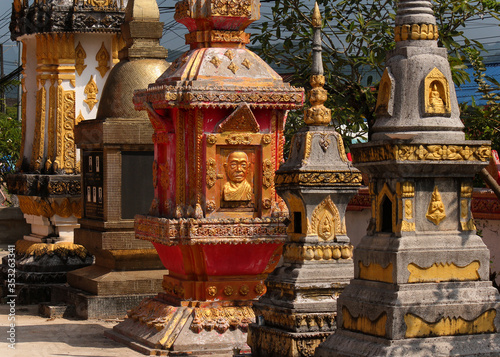 stupas as memorials decorated with golden and red colors in a buddhist temple in southeast asia