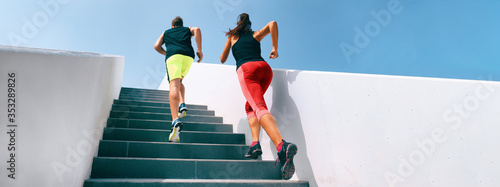 Stairs running up couple athletes runners running up staircase exercising cardio with hiit interval training workout. Fitness gym active sport people climbing in urban city panoramic banner.