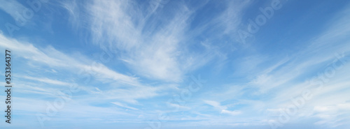 Blue sky with beautiful wispy clouds. Panoramic background.