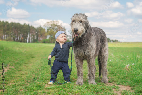 Little boy walking his dog.