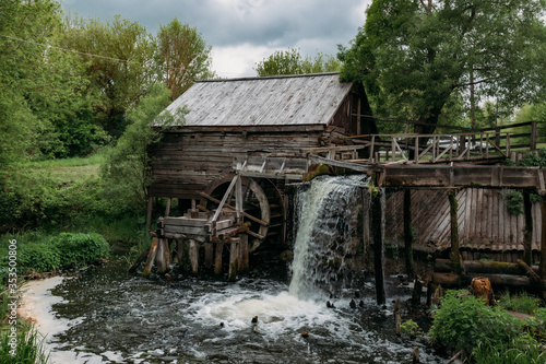 Old wooden log watermill in Russian village