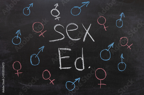 Concept of sex education on the blackboard, female and male sign.