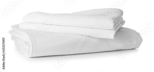 Stack of clean bed sheets on white background