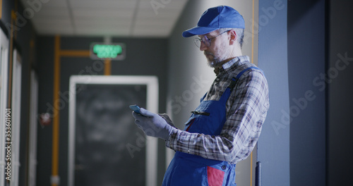 Janitor using a smartphone