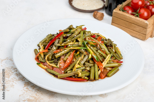 Salad of fern, vegetables sprinkled with sesame seeds