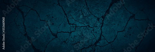 Blue grunge background. Stone background with cracks. Dark blue grunge banner with cracked concrete wall surface texture.
