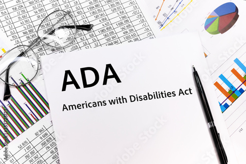ADA Americans with Disabilities Act Concept. the inscription on the sheet. pen, glasses, documents, graphics.