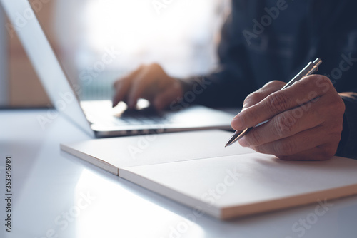 Business man working on laptop computer surfing the internet in office or student learning online course