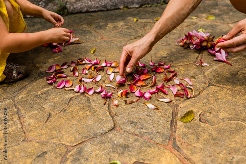 Girls playing wiht petals of flowers in Botanical gardens, Kuala Lumpur, Malaysia