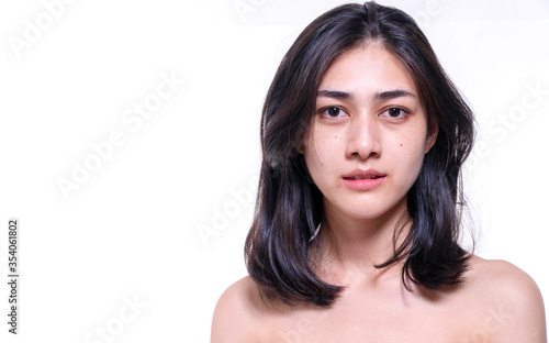 Beautiful young woman without make up on her face no retouch, fresh face while looking at camera on isolated white background. Facial treatment, cosmetic, spa, make up, beauty surgery clinic concept.