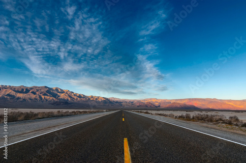 The road crossing the desert and going straight to the mountains.
