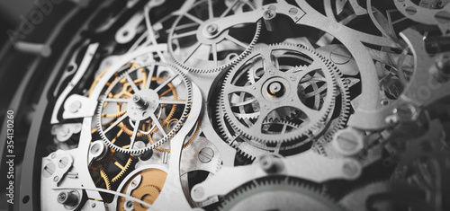 Gears and cogs in clockwork watch mechanism. Craft and precision