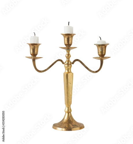 Gold classic candlestick with three candles on a white background