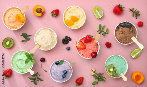 Various colorful ice cream sorts with fruits in paper cups
