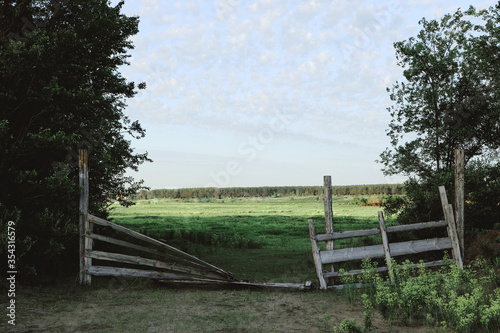 Broken gate in corral for cattle cows and horses on farm.