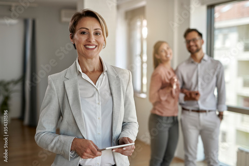 Portrait of happy female real estate agent.