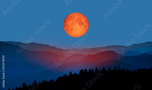 Bloody moon of Total Lunar Eclipse with blue mountains "Elements of this image furnished by NASA "