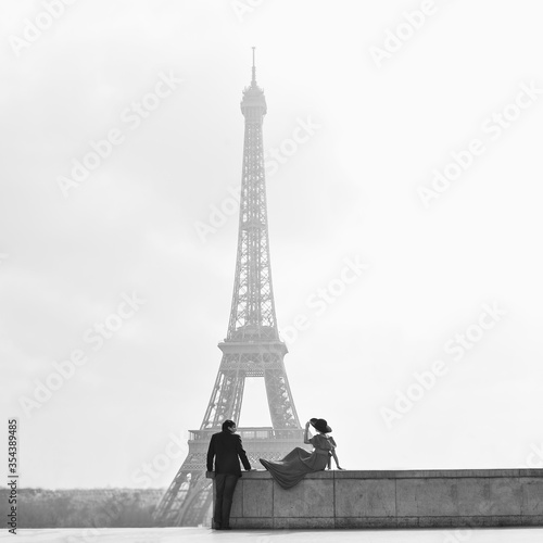 black-white. man and woman in hat on Eiffel tower in Paris. symbol of France.